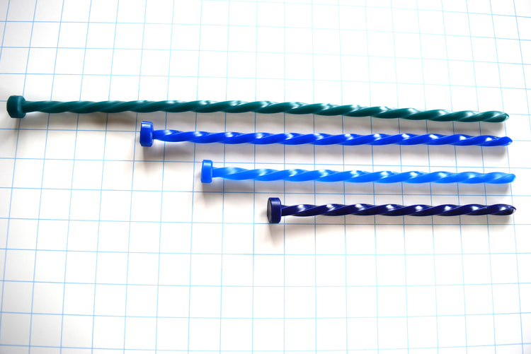 SSND-SPIRAL 10mm continuous twisted silicone urethral sounds displayed in teal, royal blue, sky blue, and dark indigo variants on a grid background, showing the rounded entry tips, four-sided 30 French helical spiral shafts, and flat safety flanges