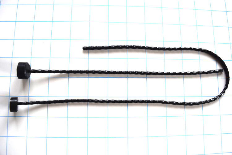 Black spiral-twisted silicone urethral sounds shown in different lengths on a blue grid background.
