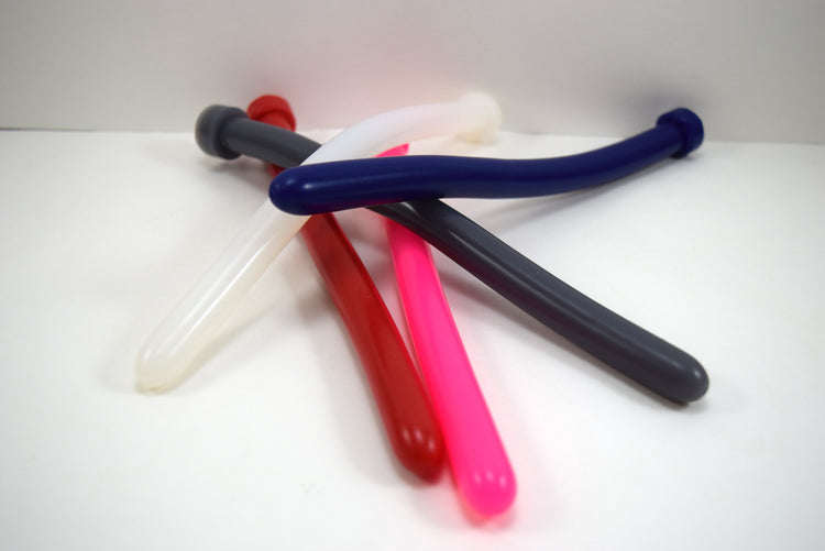 A pile of SSND 14mm silicone sounds called The Rod shown in multiple colors including navy blue, pink, red, translucent white, and charcoal gray.