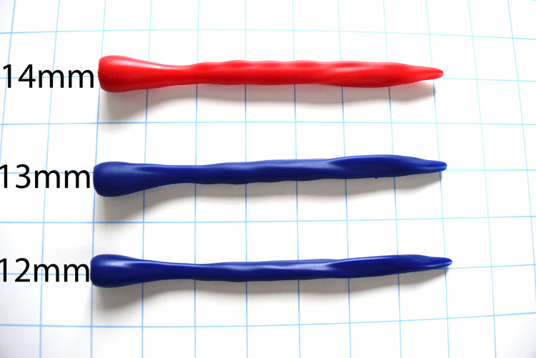 Three SSND-THING silicone urethral sounds in 14mm red, 13mm blue, and 12mm blue lined up horizontally on a blue grid background with printed diameter labels.