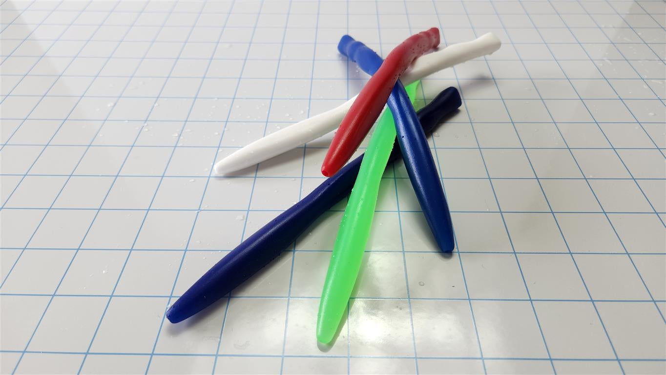 Four colourful (red, white, dark blue, green) flexible silicone SSND Tri-Sided RIPPLE urethral sounds, 8 inches long, clustered on a white grid background showing unique triangular ripple geometry.