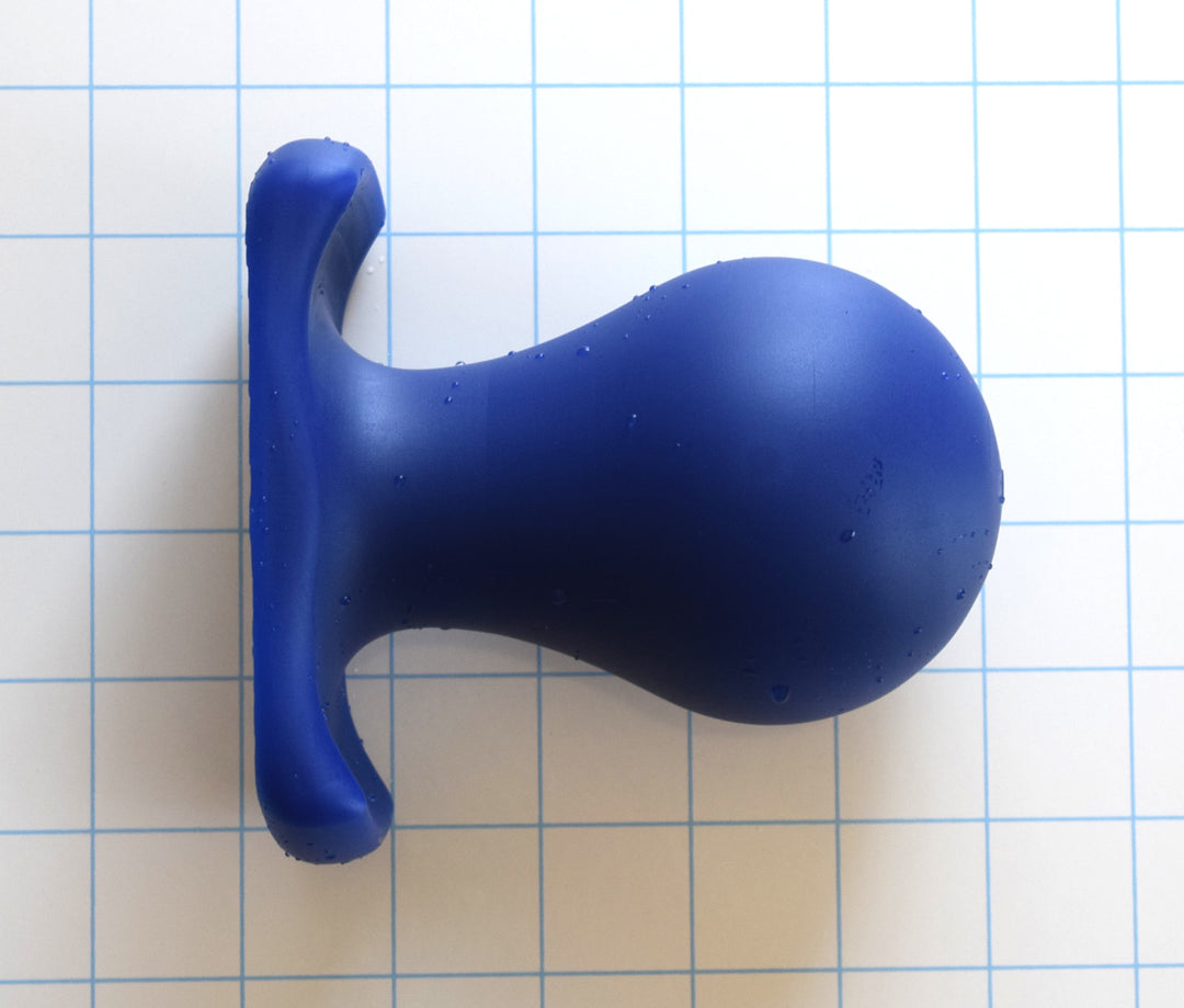 The Orb 3-inch bulb-style silicone retention plug cast in solid royal blue on a white grid background, highlighting the 3-inch maximum diameter sphere and contoured oval gluteal base flange