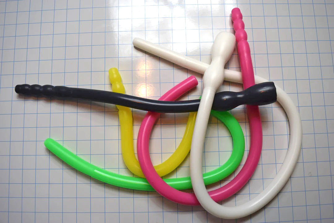 Assorted 0.825-inch diameter silicone colon tubes in various colors and designs, shown on a grid background